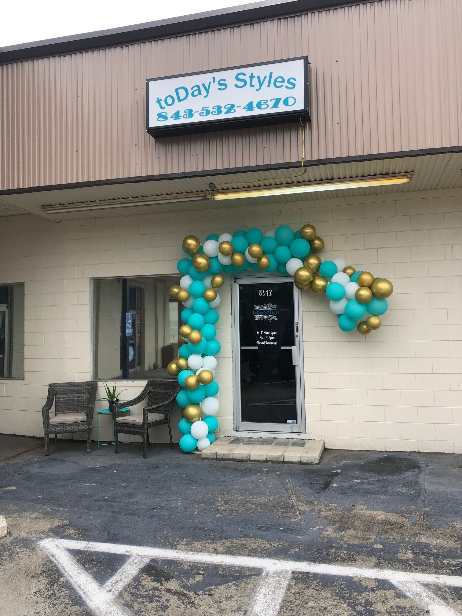 The toDay's Styles storefront on Central Ave with a teal and gold balloon arch